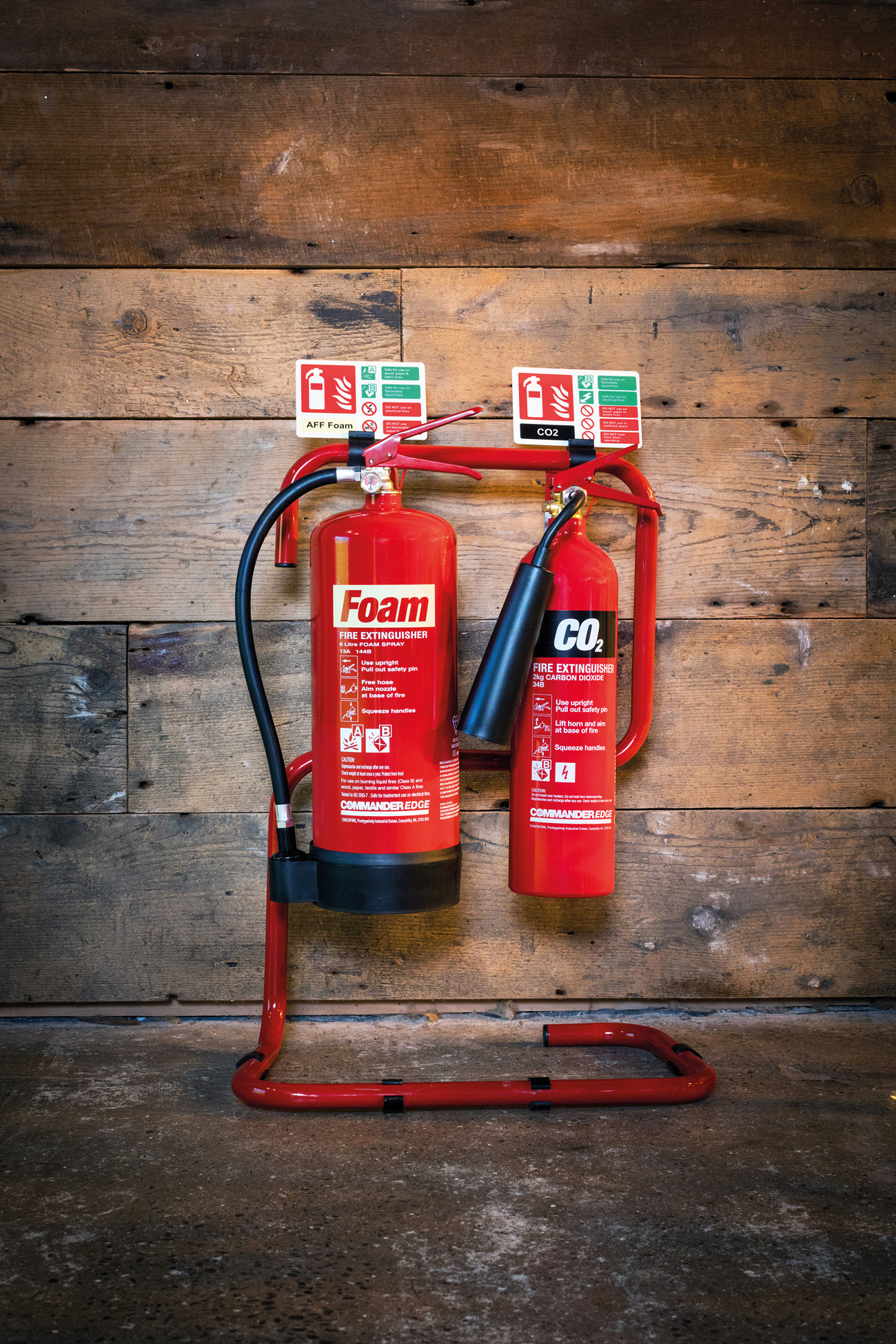 CommanderEDGE extinguishers secured by the Red Tubular Fire Extinguisher Stand.
