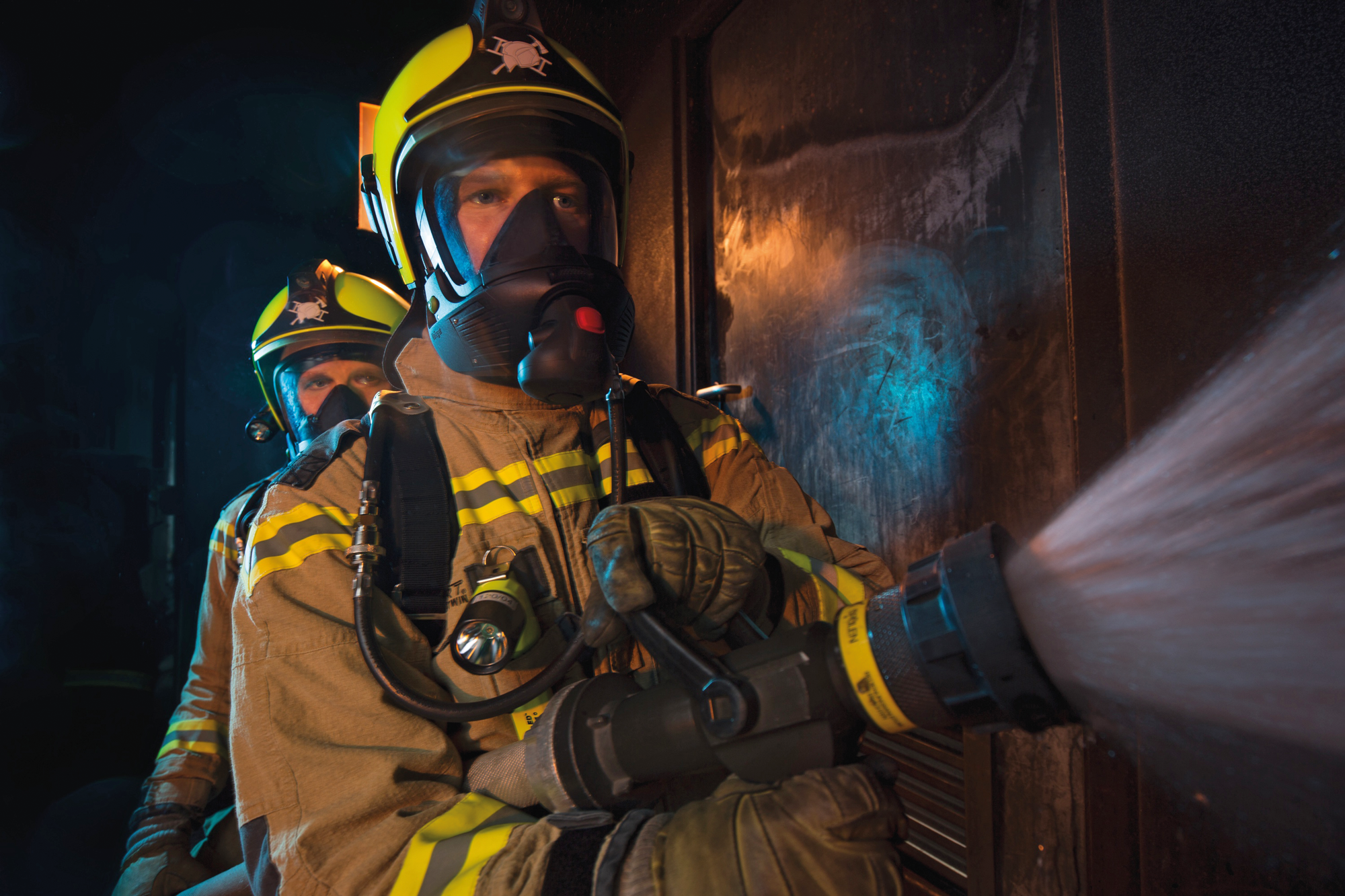 Firefighters wearing breathing apparatus from Dräger.