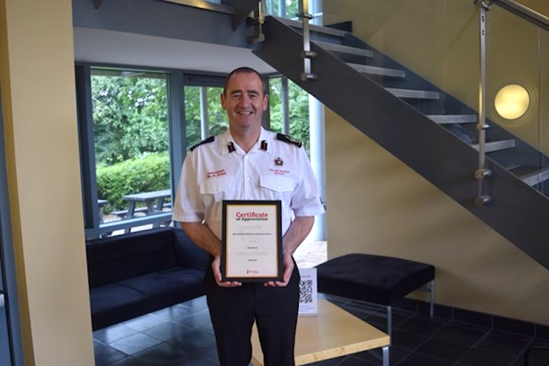 Deputy Chief Fire Officer Roger Thomas recieves the certifiacte of appreciation from the Fire Fighters Charity. (MWWFRS)