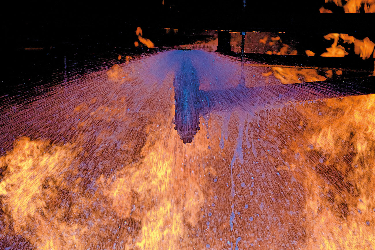 Foam assisted standard upright sprinklers during fire testing.