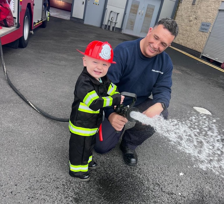 Vinnie Hall with Firefighter John Foreman of Green Watch at Marley Park Community Fire Station. (TWFRS)