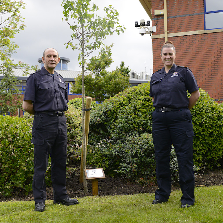 DCFO Peter Heath and ACFO Lynsey McVay planting the tree at the TWFRS HQ in Washington. (TWFRS)