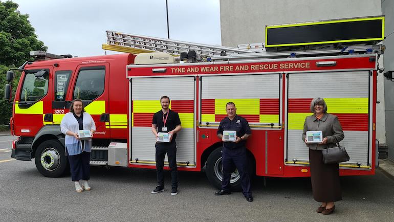 From left: Emmalene Charlton – Tyneside and Northumberland Mind; Matty Starforth, Public Health Officer at Newcastle City Council; TWFRS Firefighter Tommy Richardson; and Laura Lawrence – TWFRS Trauma Support and Welfare Manager standing in front of an appliance at Byker Community Fire Station. (TWFRS)