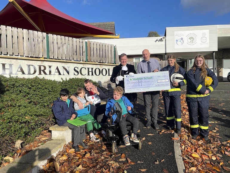 West Denton Fire Cadets, The High Sheriff of Tyne and Wear, and representatives from Hadrian’s School being presented with a cheque. (TWFRS)