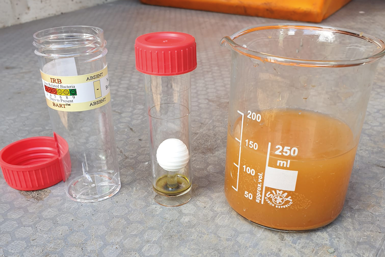 Photo shows the test vial (centre) once it has been removed from the outer dispenser.