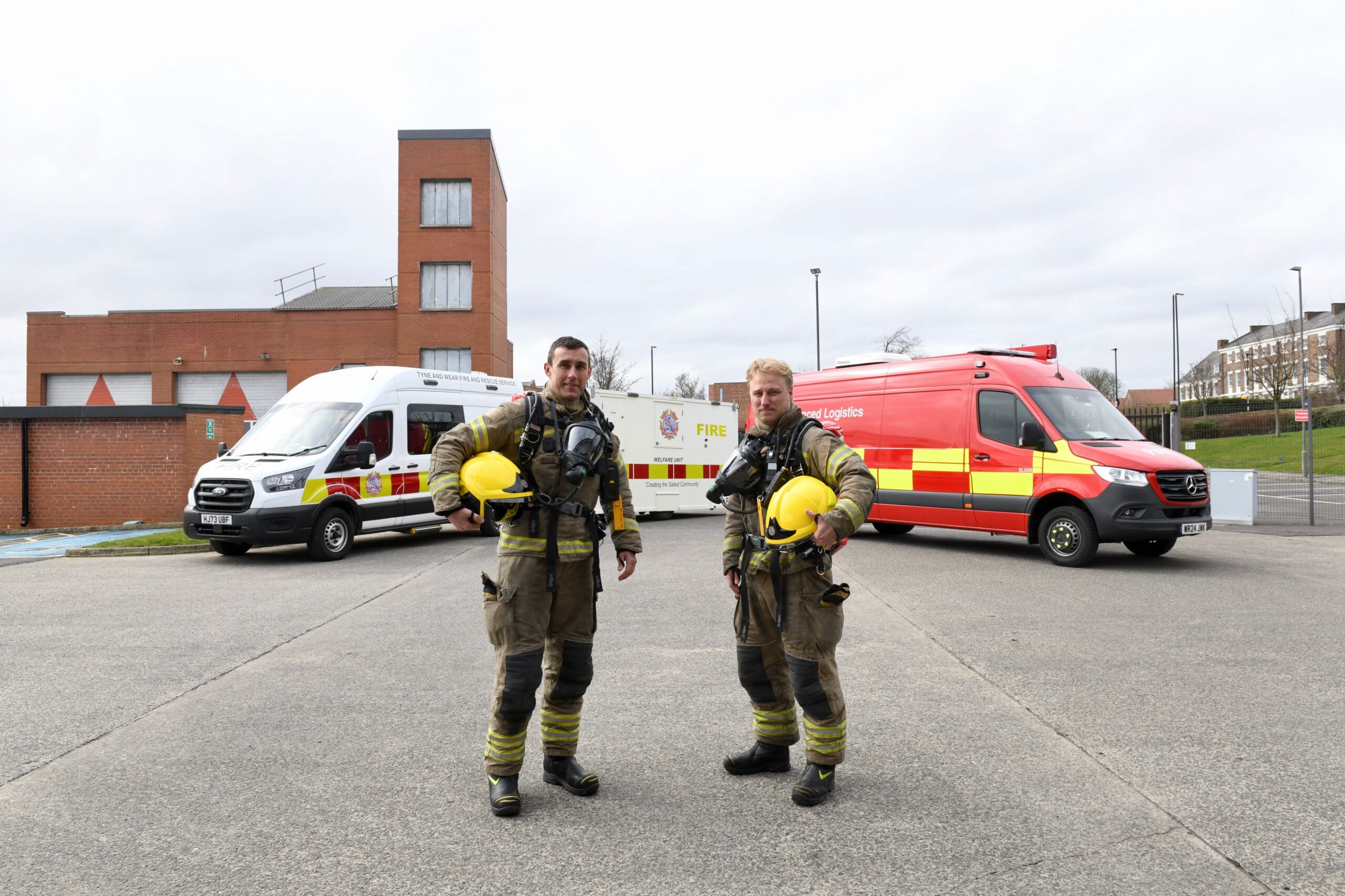 Two TWFRS Firefighters wearing the new specialist Breathing Apparatus (BA) sets from Draeger Safety UK Ltd. Pictured in front of the new Welfare and Enhanced Logistics Support Vehicles.